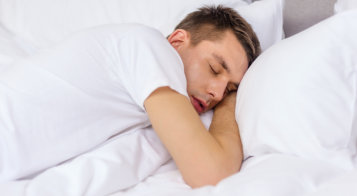 Man sleeping peacefully in bed during a home sleep study