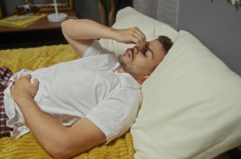 sleep apnea patient holding deviated septum