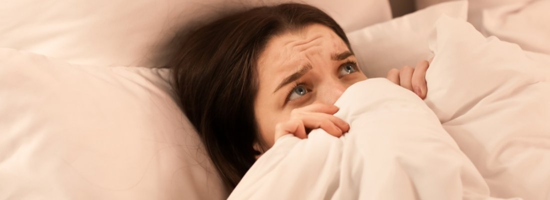 scarred woman in bed suffering from somniphobia