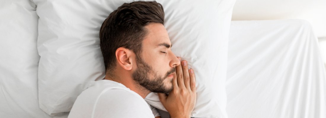 young man having peaceful deep sleep